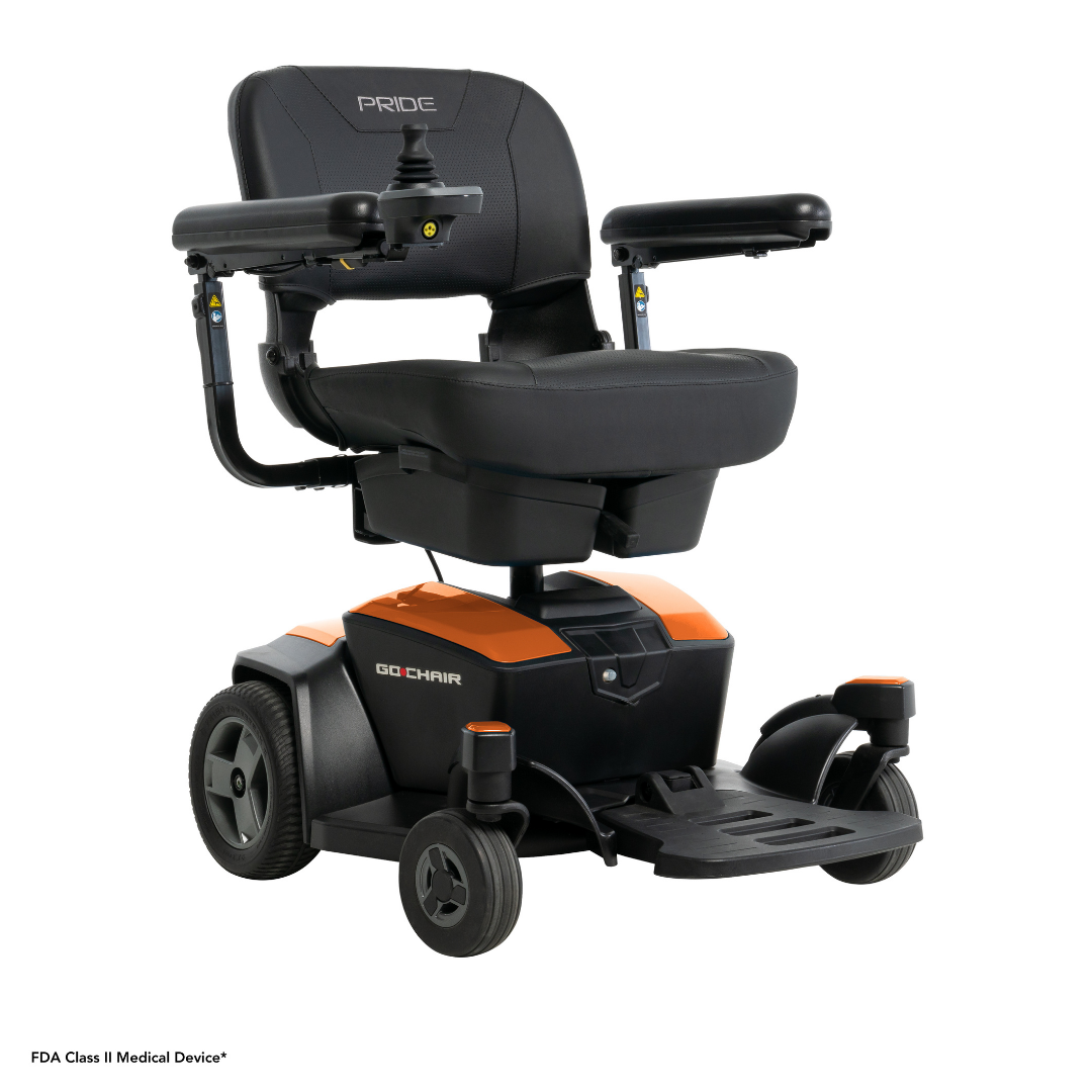 The Pride Mobility Go Chair® Portable Powerchair is a black and orange motorized mobility chair with a padded seat, armrests, joystick control, enhanced agility, two large rear wheels, and two small front wheels.
